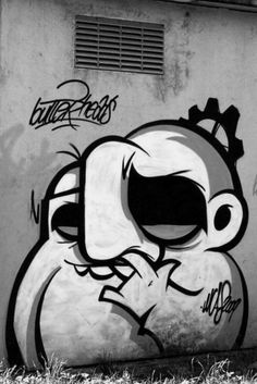 black and white photograph of graffiti on the side of a building with an angry bird