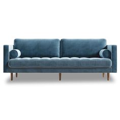 a blue couch sitting on top of a white floor