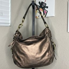 Coach Euc Bronze Leather Purse, Hardly Used, With Inside Pockets. Height: 12” Length: 12” Width: 4.5” Elegant Gold Hobo Bag, Elegant Gold Hobo Bag With Metal Hardware, Elegant Evening Hobo Bag With Brass Hardware, Coach Gold Shoulder Bag With Metal Hardware, Gold Coach Shoulder Bag With Metal Hardware, Elegant Hobo Bag With Brass Hardware For Daily Use, Elegant Rectangular Hobo Bag With Brass Hardware, Elegant Gold Hobo Bag For Travel, Elegant Coach Hobo Bag With Silver-tone Hardware