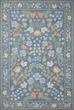 a blue rug with flowers and leaves on the bottom, surrounded by other floral designs