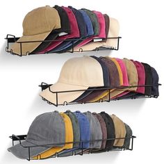 multiple hats and caps are hanging on the wall with metal racks for each one to hold them