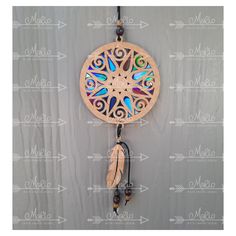 a wooden dream catcher hanging on a wall with an arrow and name written below it