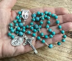 Gemstone Catholic 5 decade rosary made with 5mm turquoise beads,8mm gemstone beads on the place of Our father beads,miraculous medal centrepiece and st benedict crucifix. Give a gift of love and prayer with these wonderful rosaries. Hand made in Medjugorje. Feel free to contact me if you have any question. Thank you for stopping by! For more similar items and different colors visit our store: https://www.etsy.com/shop/Thelightjewelry?ref=seller-platform-mcnav Turquoise Spiritual Rosary Bracelet With Round Beads, Turquoise Rosary Bracelet With Round Beads, Spiritual Turquoise Rosary Bracelet With Round Beads, Turquoise Rosary With Round Beads, Spiritual Turquoise Rosary With Round Beads, Turquoise Rosary With Round Beads As Gift, Rosary Prayers Catholic, St Benedict Cross, Beads Rosary