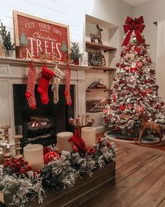 the christmas tree is decorated with red and white stockings on it's mantles