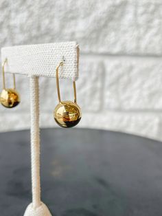 The metal spheres and mobile-inspired design create a contemporary and weightless variation of the classic drop earring. Finished in luxurious high-polish gold. Modern Gold Plated Earrings For Formal Events, Modern Gold Plated Earrings For Formal Occasions, Modern Gold Plated Evening Earrings, Modern Dangle Earrings With Polished Finish, Modern Gold Plated Earrings For Evening, Modern Matte Gold Metal Earrings, Modern Gold Earrings With Shiny Finish, Modern 14k Gold Hoop Earrings For Evening, Modern Metal Drop Hoop Earrings