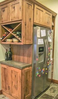 a refrigerator freezer sitting inside of a wooden cabinet