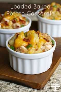 loaded baked potato casserole with bacon and green onions in white dishes on a wooden tray