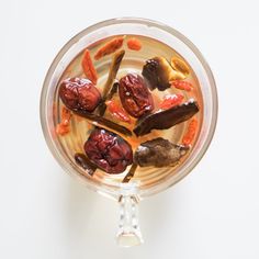 a glass bowl filled with food on top of a white table