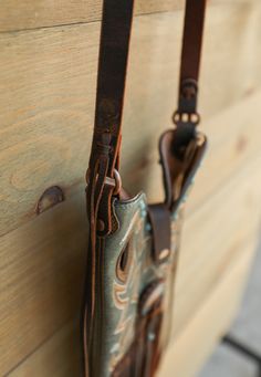 Big Timber Boot Crossbody Bag Looking for something unique ... well here it is! The Big Timber Boot Crossbody Bag is handcrafted in Texas, U.S.A. This one of a kind leather bag is made from recycled cowboy boots! Features cream stitched blue leather uppers adorned with buckle and leather accent, leather strap with magnetic closure, leather horse reins as strap, and dark brown hand stitched leather fringe. This Western bag is the perfect size to hold your phone, small wallet, and a few essentials Timber Boots, Big Timber, Western Bag, Leather Fringe, Small Wallet, Stitching Leather, Graphic Tee Shirts, Blue Leather, Cowboy Boots