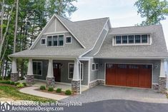 a large house with two garages and lots of windows on the front of it