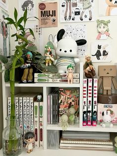 a white shelf filled with lots of books and figurines on top of it