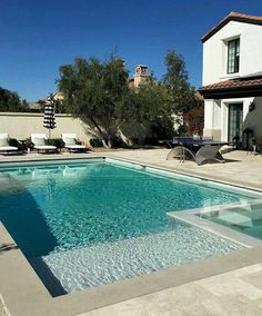 an empty swimming pool in front of a house