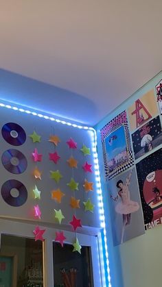 a room with various decorations and lights on the wall, including star - shaped stickers