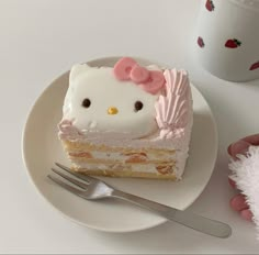 a hello kitty cake on a plate with a fork