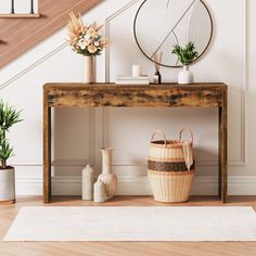 a wooden table sitting under a stair case next to potted plants and vases