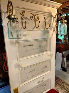 a white door with some glass jars on it