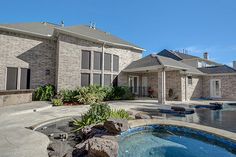 a large house with a swimming pool in the front yard