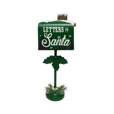 a green mailbox with the words letters to santa written on it and holly decorations