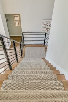 the stairs are made of wood and have metal handrails, with carpet on them