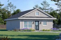 a small gray house sitting on top of a lush green field