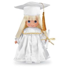 a doll dressed in a graduation gown and holding a diploma cap with a tassel on it