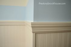 the corner of a room with blue and white walls