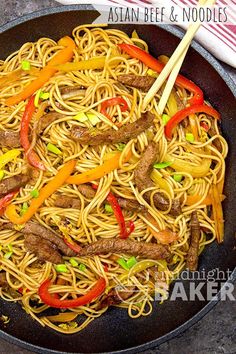 stir fried noodles with beef and peppers in a skillet