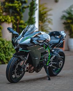 a black and green motorcycle parked on the street