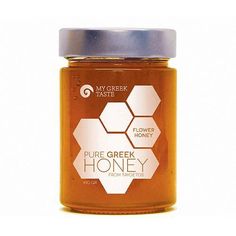 a jar of pure greek honey on a white background