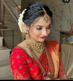 a woman in a red and gold sari