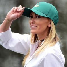 a woman wearing a green hat and white shirt