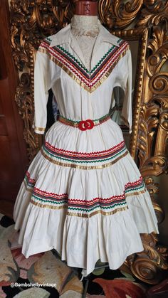 "This fabulous patio dress is from the 50's Made of a natural cotton. Fit and flare style with beautiful red, green and metallic gold trim. This came to me with no belt buckle. I added this 1930's deadstock red Casein buckle. The elastic that was in the waist has no stretch. You could replace it or leave it as is and just cinch with the belt. There are only a few very tiny spots withing the gathers of the skirt.  Very hard to see. Best fit would be a Small, however, please see the measurements b Patio Dress, Fiesta Dress, 50s Fashion, Green Gold, Dress Clothes For Women, Belt Buckle, Metallic Gold, Gold Trim, Natural Cotton