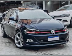 a black volkswagen car parked in front of a building