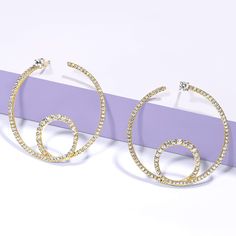 The Shimmering Loop Bardot Hoops are artistic and minimalistic. They're made with solid gold and ethically sourced natural diamonds, adding a touch of shimmer to any outfit. The loop design adds an element of movement to the hoops, making them a dynamic addition to your jewelry collection. Anniversary Yellow Gold Rhinestone Jewelry, Gold Jewelry With Sparkling Stones, Dazzling Yellow Gold Rhinestone Jewelry, Dazzling Yellow Gold Jewelry With Rhinestones, Glamorous Yellow Gold Jewelry With Sparkling Stones, Modern Jewelry With Rhinestones And Cubic Zirconia, Elegant Yellow Gold Jewelry With Rhinestones, Modern Cubic Zirconia Jewelry With Rhinestones, Glamorous Sparkling Yellow Gold Jewelry