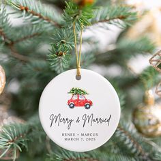 a christmas ornament hanging from a tree with a red car on it's front