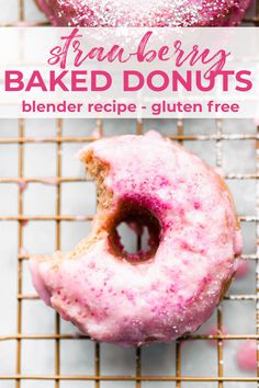 two pink glazed donuts sitting on top of a cooling rack next to each other