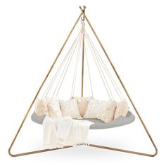 a hanging chair with pillows on it