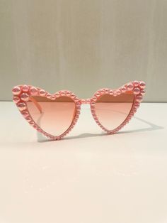 Custom Pearl Heart Sunglasses for women. These sunglasses are absolutely beautiful they are fully bedazzled with pearls! Perfect for birthdays, bridal party, bachelorettes or vacation.  Each Pearl is placed on the sunglasses by hand. Can be customized with any name or saying or can be left with only pearls.  If you have any questions please feel free to send a message. Also send a message if you would like to order in bulk. Sunglasses dimension: the lenses measure approx. 5.3 cm/ 2.1 inches in w Elegant Pink Sunglasses For Party, Elegant Heart-shaped Party Sunglasses, Elegant Pink Party Sunglasses, Heart-shaped Sunglasses For Summer Weddings, Heart-shaped Wedding Sunglasses For Summer, Elegant Valentine's Day Party Sunglasses, Pink Heart-shaped Party Sunglasses, Glamorous Pink Sunglasses For Party, Glamorous Pink Party Sunglasses