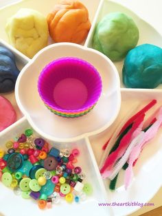 there is a plate with different colored buttons and beads in the bowl next to it