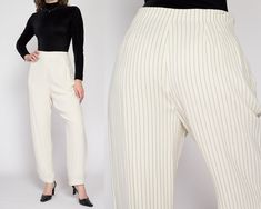 "Vintage 90s Liz Claiborne high waisted trousers in white with black pinstripes, pleating at the upper front, and a relaxed tapered leg. They have a side zipper closure. The original tag is still attached, but there are a few condition notes due to age/storage - see details below. Measurements and Condition: Fits like: Labeled size 12, fits modern women's medium to large (30\" waist) Fabric: Rayon/acetate, a semi-sheer shell over a lining layer Brand: Liz Claiborne Condition: Good, with some very faint speckled brown and gray discoloration at the front rise and left thigh, and some extremely faint yellow water staining at the upper front (barely visible, is more noticeable at the inside of the waistline - see close up). Waist: 30\" Hips: 44\" - taken at the bottom of the zipper opening Ris Pinstripe High-waisted Pants For Spring, Fitted Pinstripe High Waist Bottoms, Fitted High Waist Pinstripe Bottoms, Pinstripe High Waist Pants For Spring, Fitted High-waist Bottoms With Vertical Stripes, Elegant White Pants With Vertical Stripes, Elegant White Striped Pants, Classic Striped Pants For Spring, Classic Striped Spring Pants