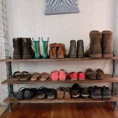 there are many pairs of shoes on the shelf next to each other in this room