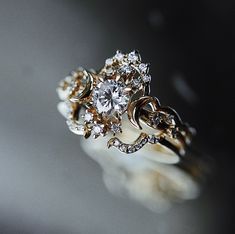 a close up view of a ring with diamonds on it's center and sides