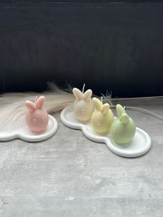 three small ceramic bunnies sitting on top of each other