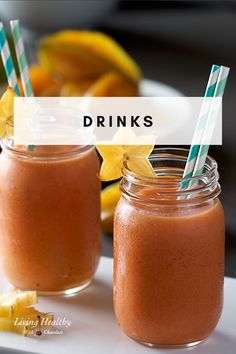 two mason jars filled with orange smoothies