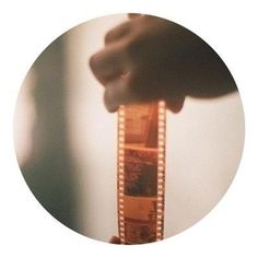 a person holding a film strip in their hand