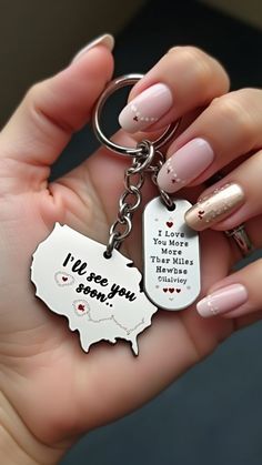 a woman's hand holding a keychain with the words i love you in it