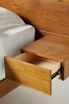 an open drawer in the side of a bed