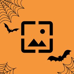 an orange background with black bats and spider webs on the bottom right corner is a square, rectangle shaped object that appears to be surrounded by smaller rectangular shapes