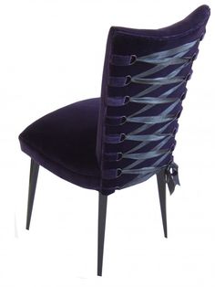 a purple chair sitting on top of a white floor