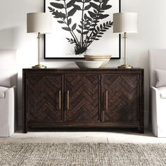 a living room with two chairs and a large painting on the wall above it's sideboard